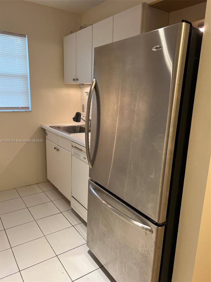 a kitchen with stainless steel appliances a refrigerator and a sink