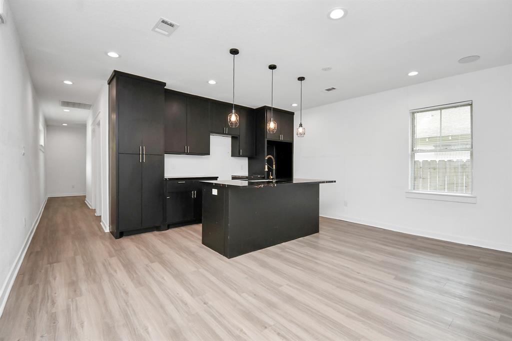 a kitchen with a refrigerator and a sink