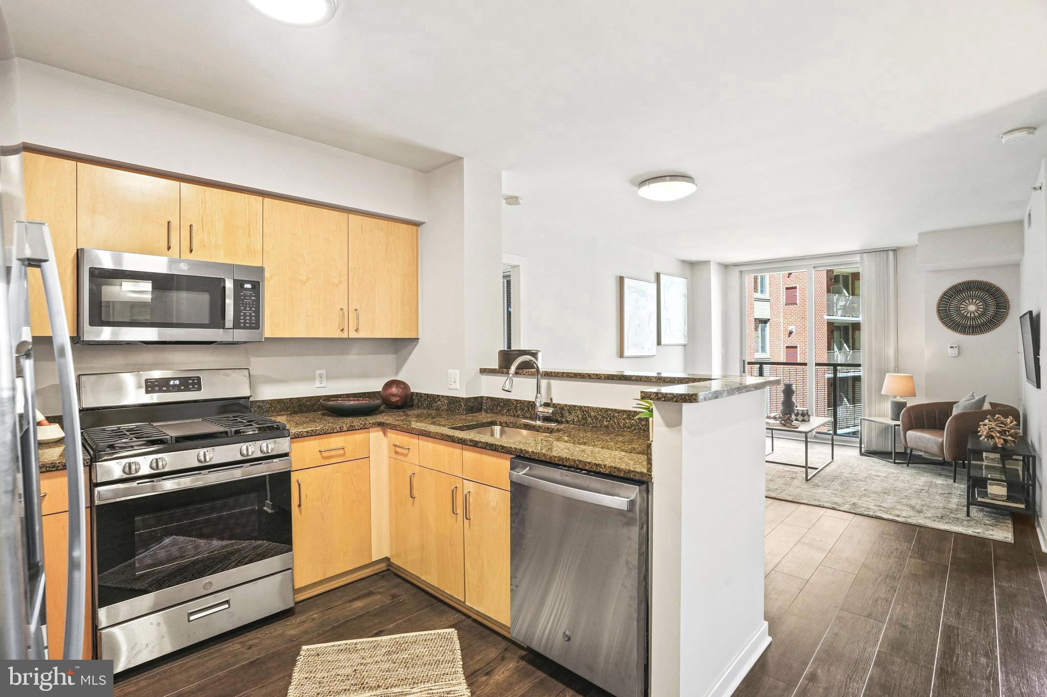 a kitchen with stainless steel appliances a stove sink and microwave