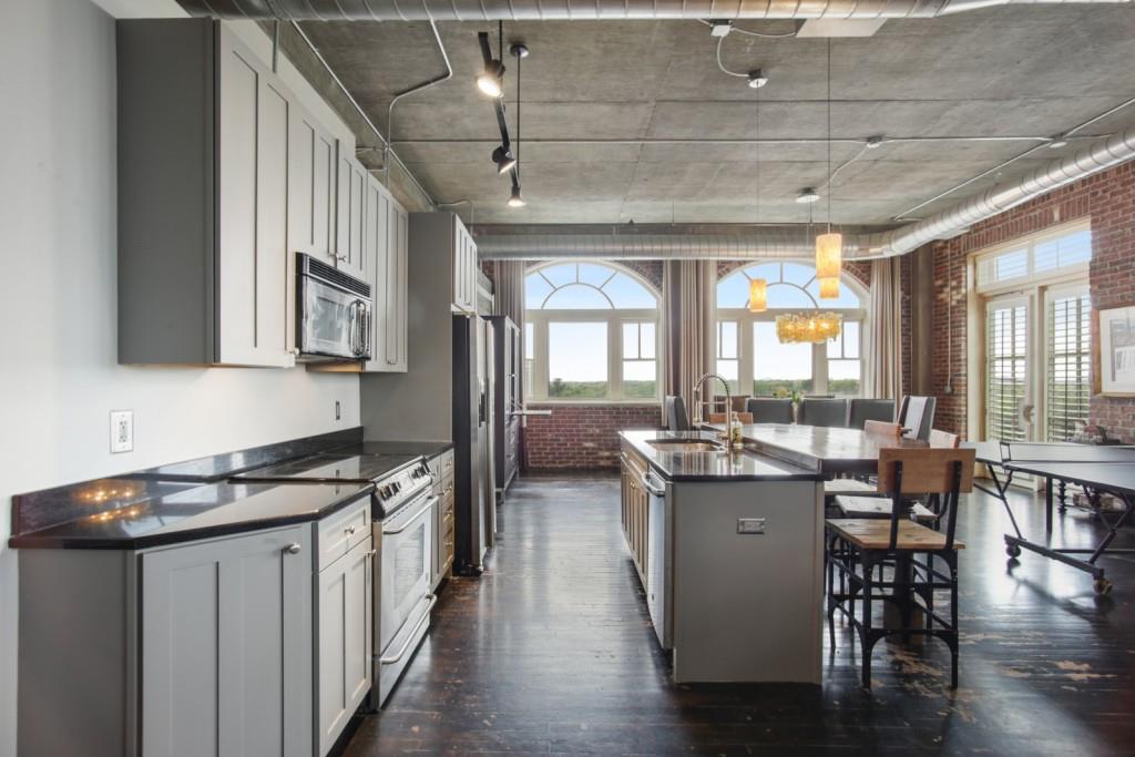 a kitchen with lots of counter top space and wooden floor