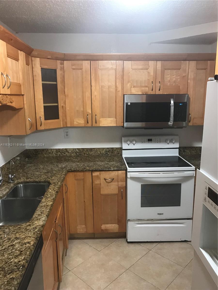 a kitchen with a stove and a sink