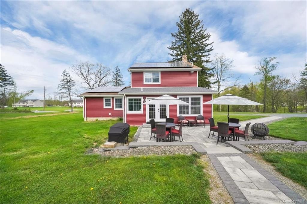 a view of a house with a yard porch and sitting area