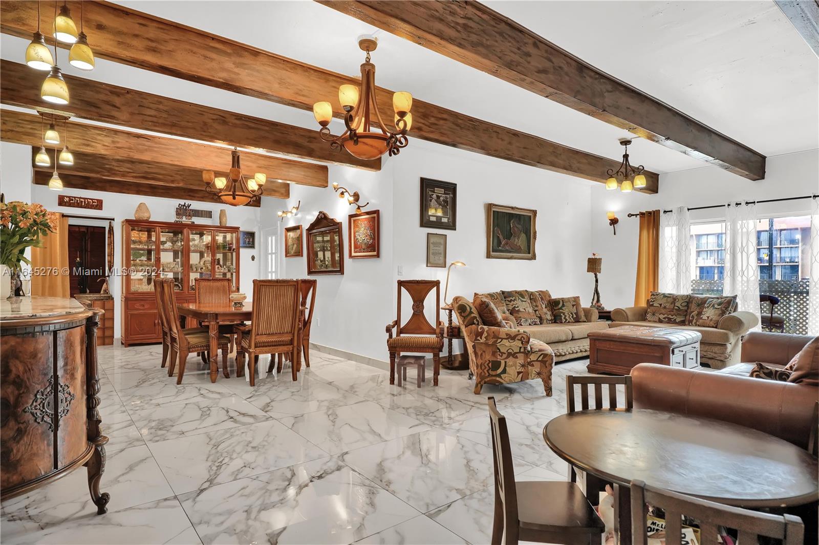 a living room with lots of furniture and a chandelier