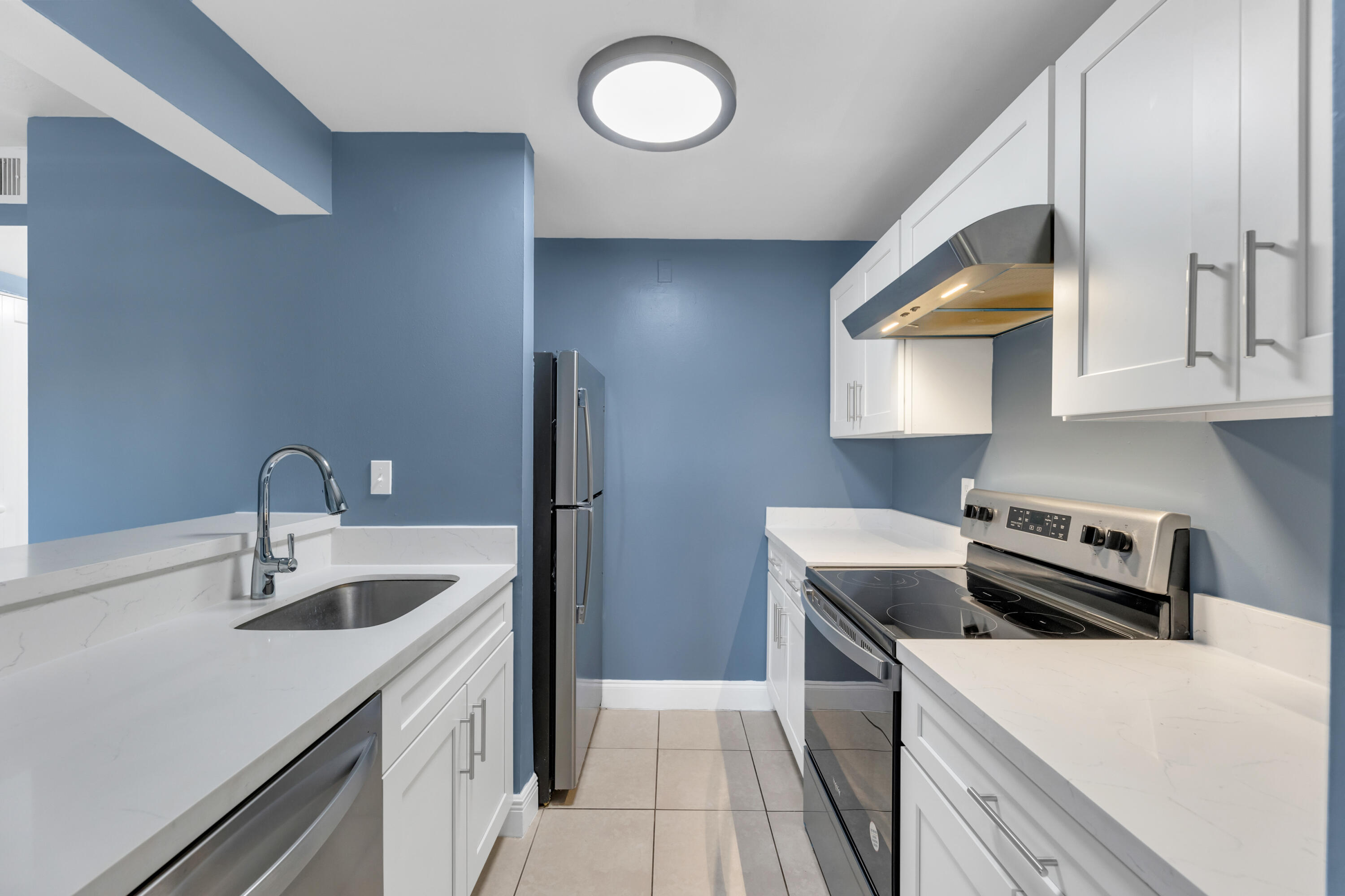 a kitchen that has a sink and a stove