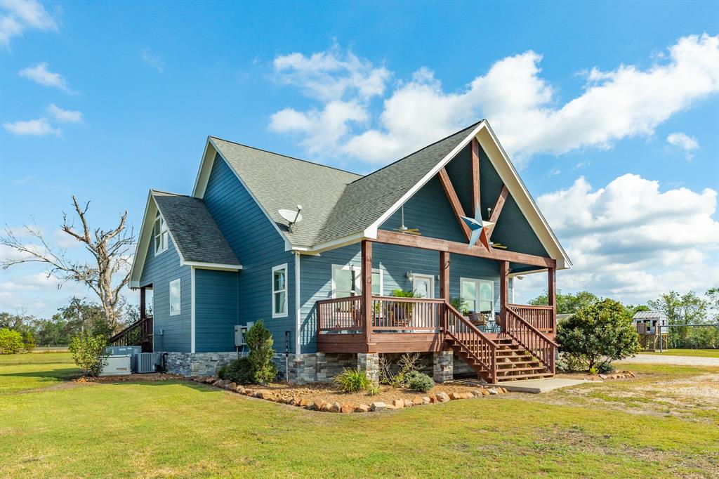 a front view of house with yard swimming pool and outdoor seating