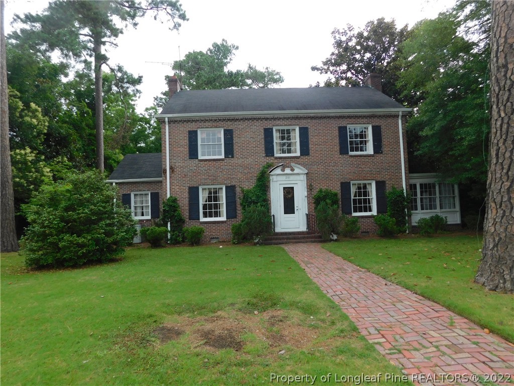 a front view of a house with a garden