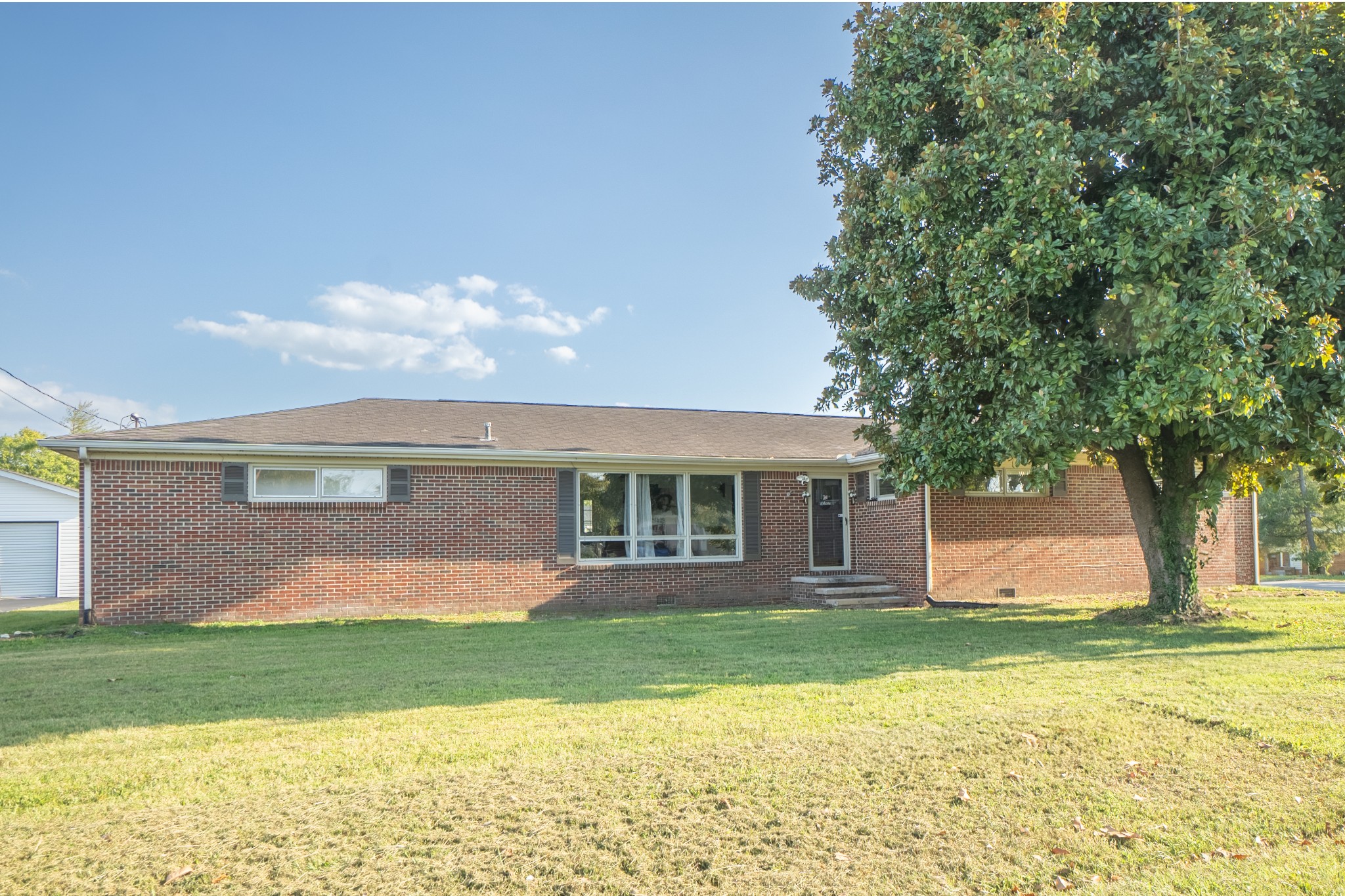 a front view of house with yard and green space