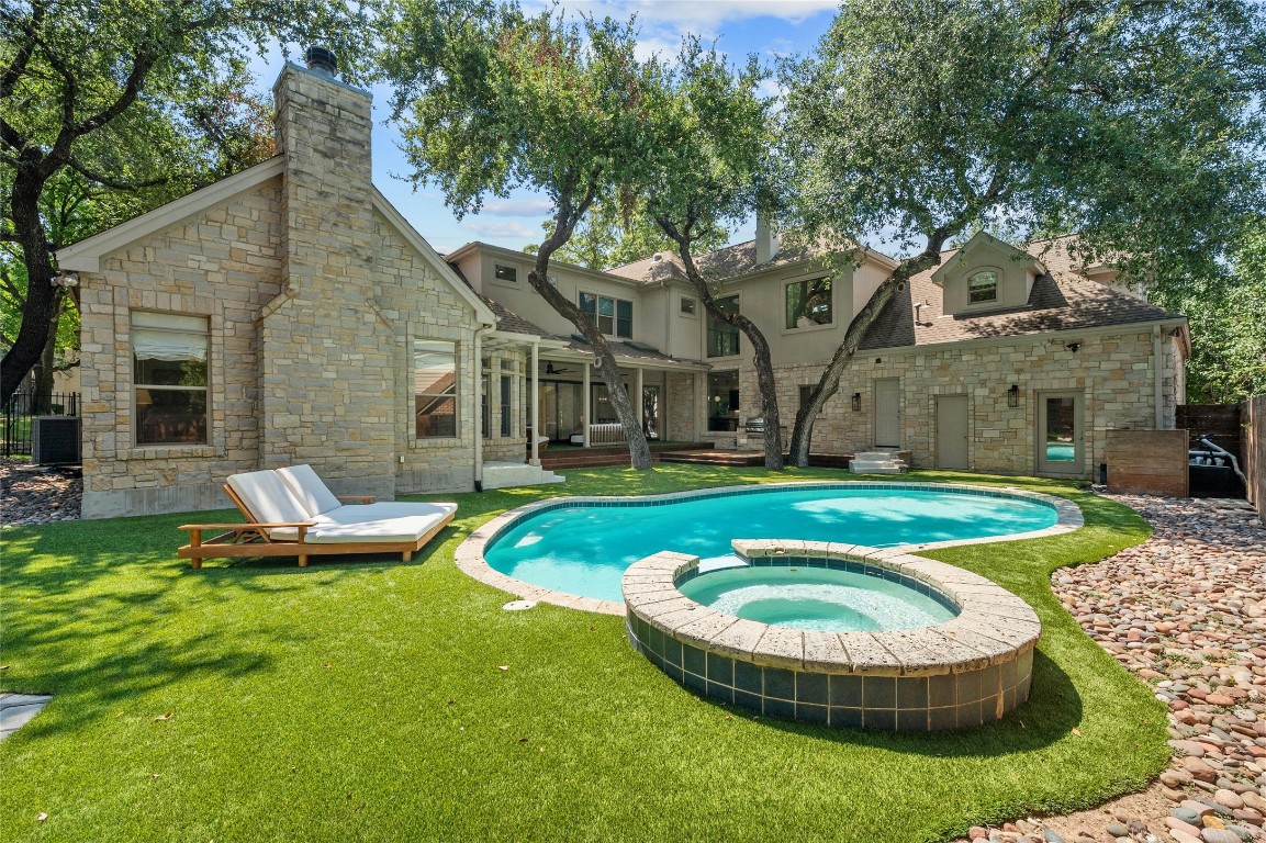 a view of a house with a yard patio and fire pit