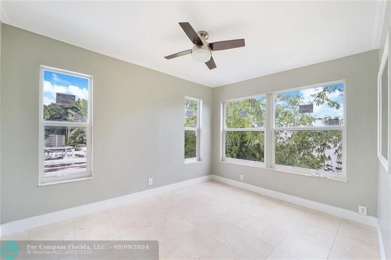 a view of a livingroom with a ceiling fan and window