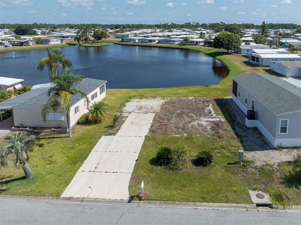 an aerial view of a house with a lake view