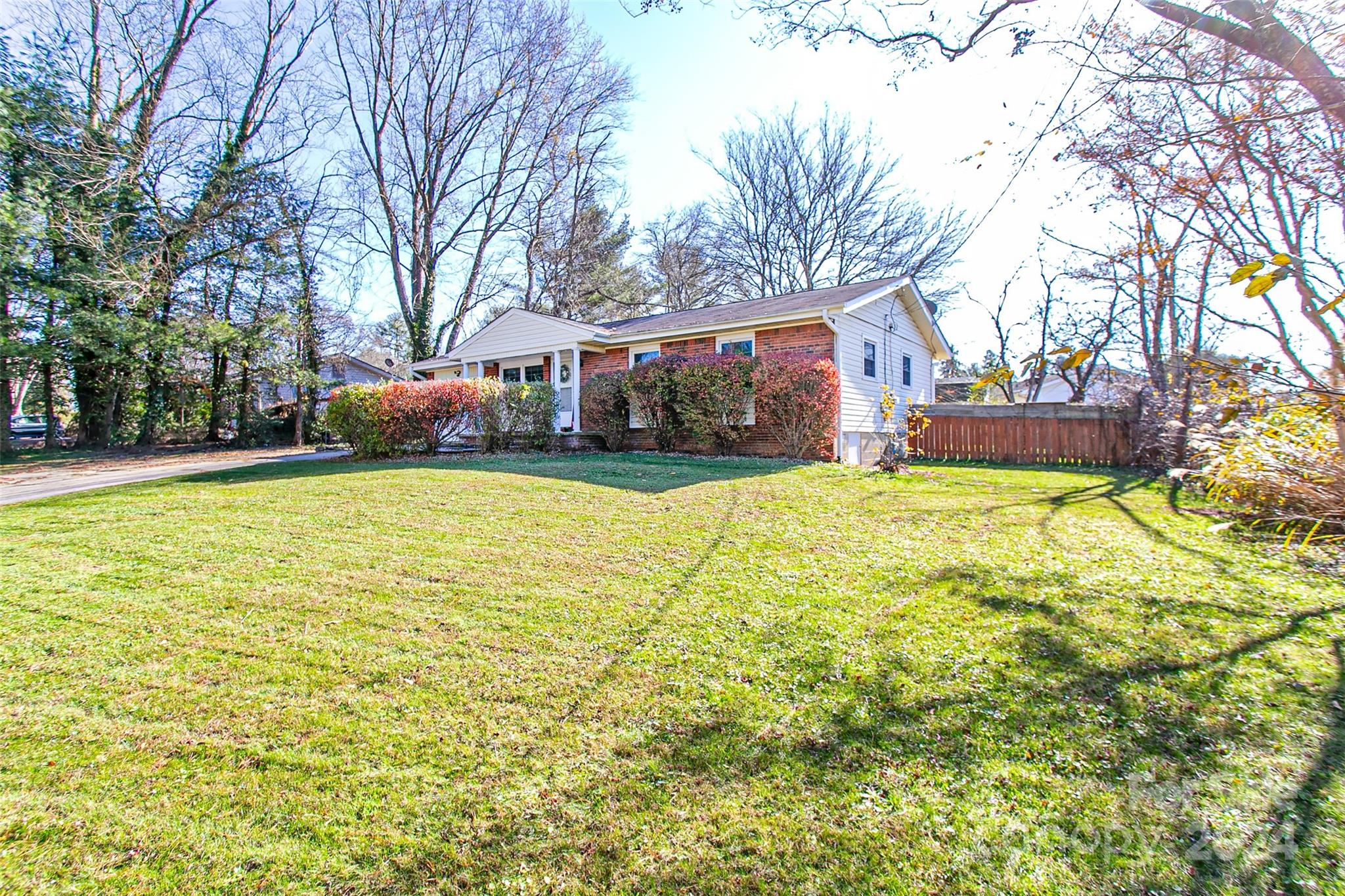 a view of a house with a yard and trees