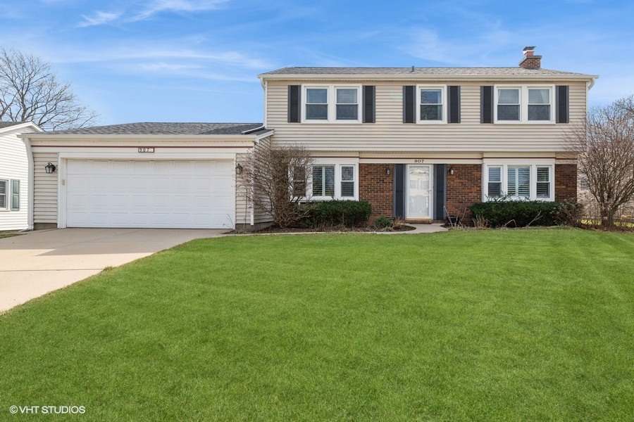 a front view of house with yard and green space