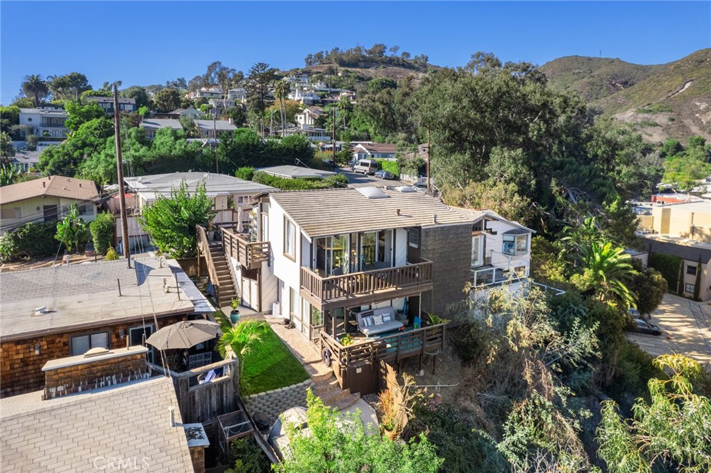 an aerial view of a house with a big yard