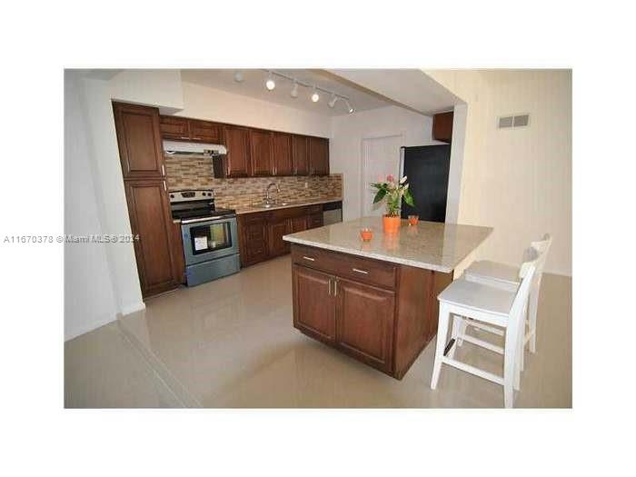 a kitchen with a sink cabinets and stainless steel appliances