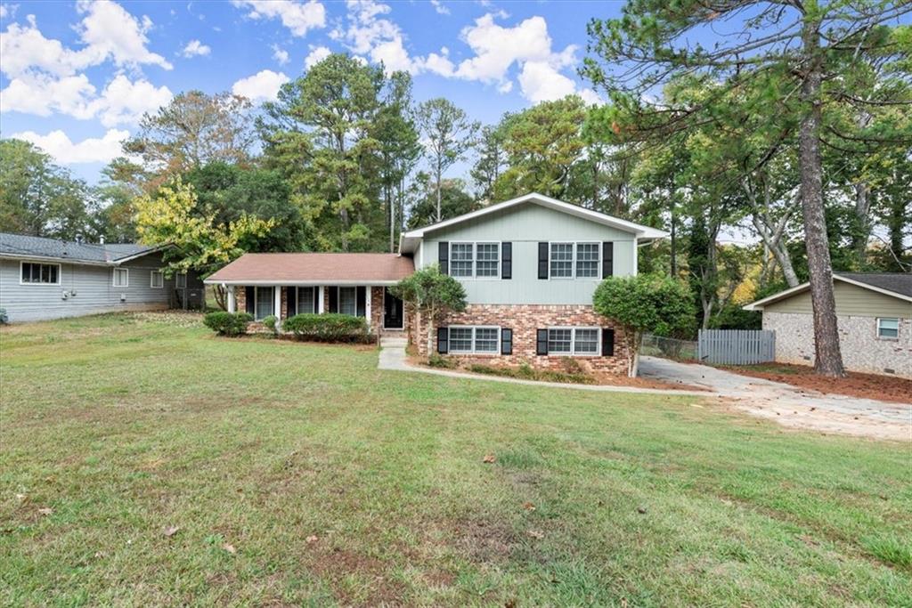 a front view of a house with a garden