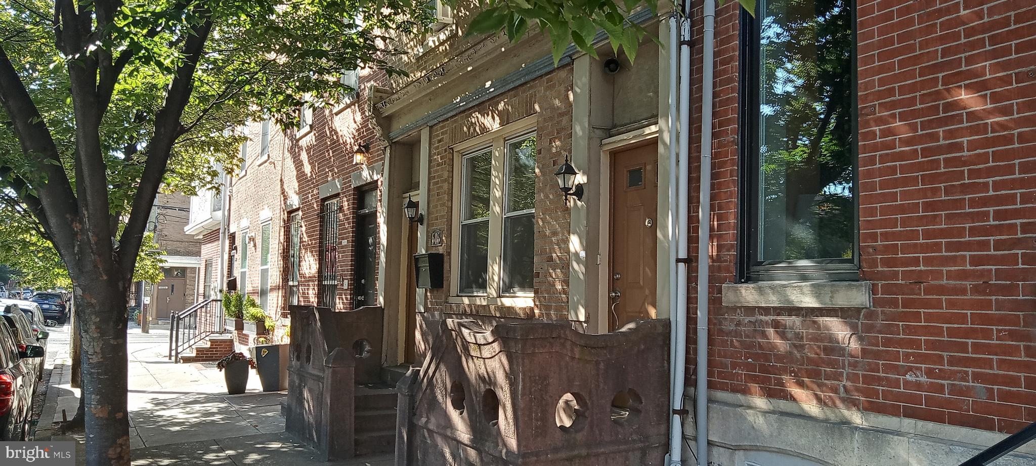 a view of a house with a tree