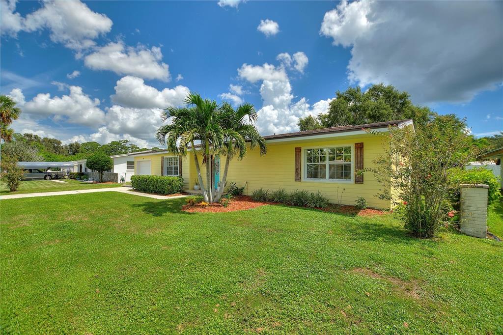 a view of a house with a backyard