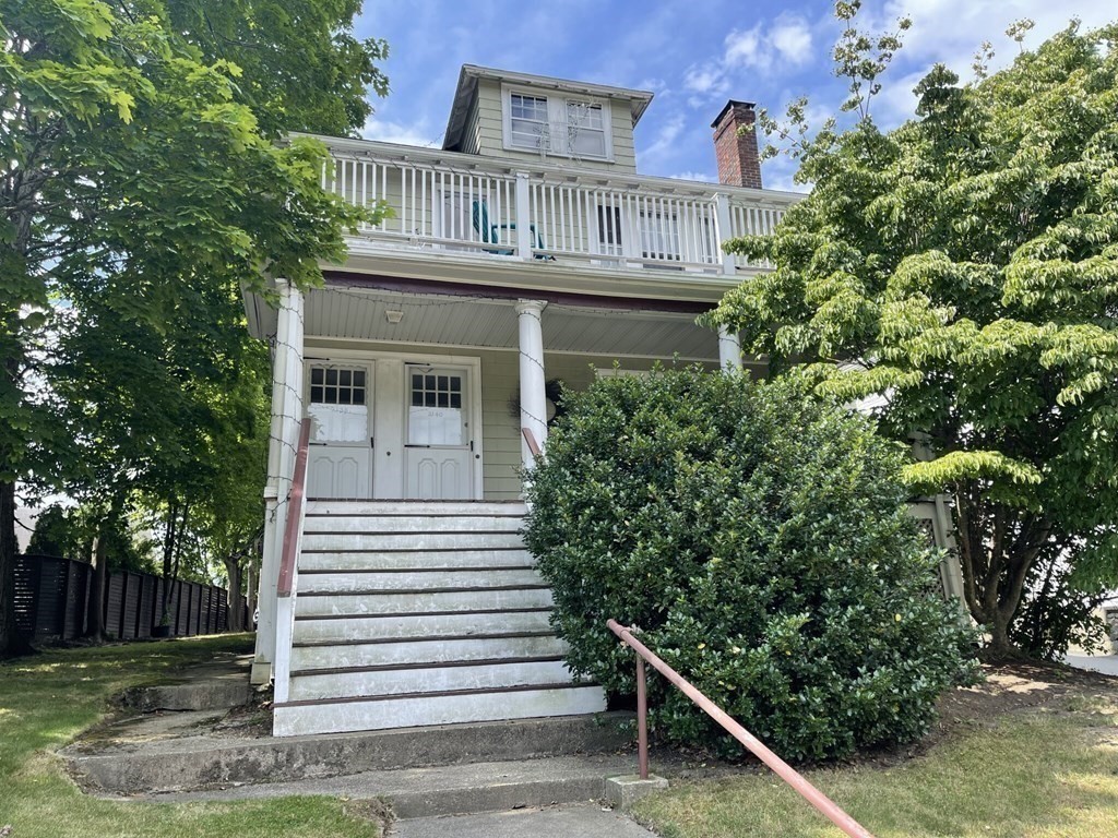 a front view of a house with plants