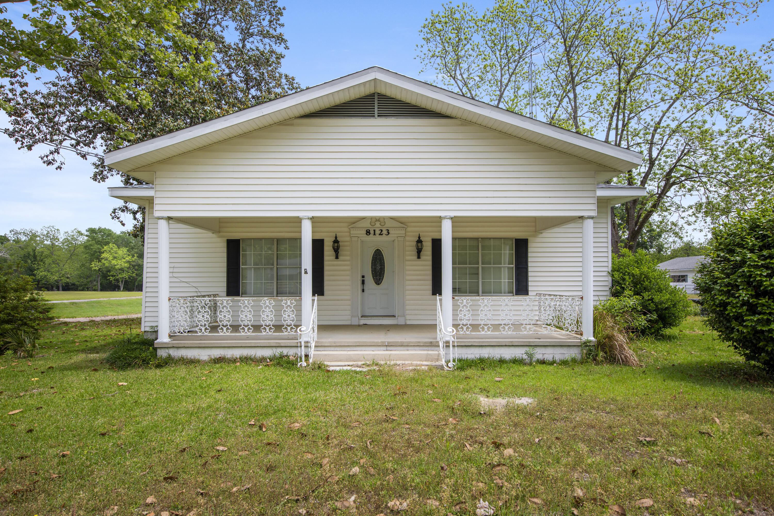 a view of a house with yard and sitting area