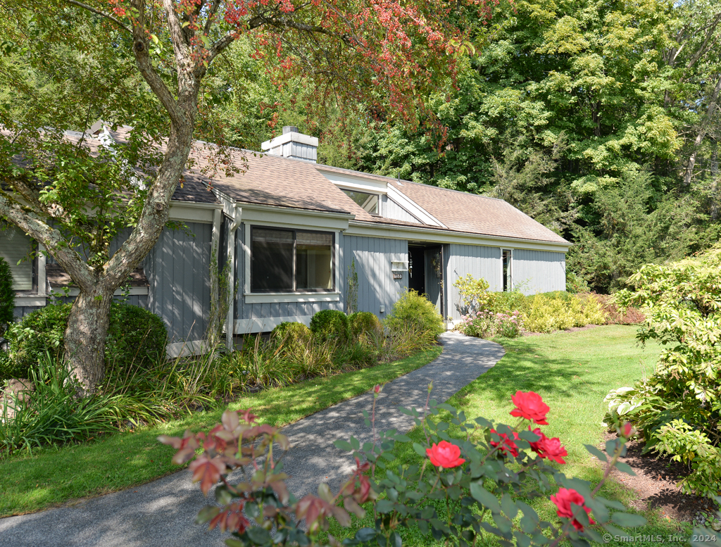 a house view with a sitting space and garden