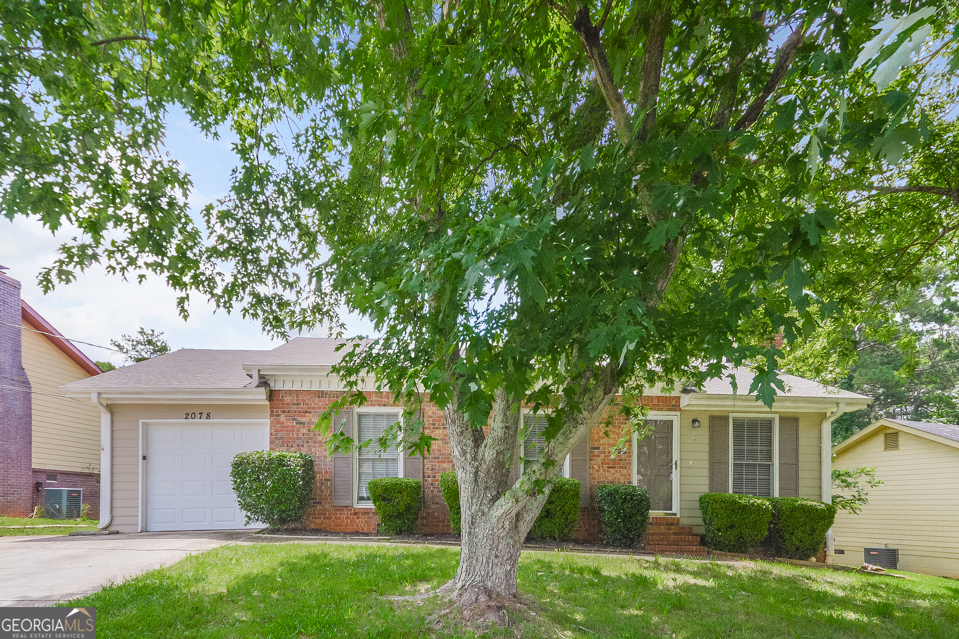 a front view of a house with garden