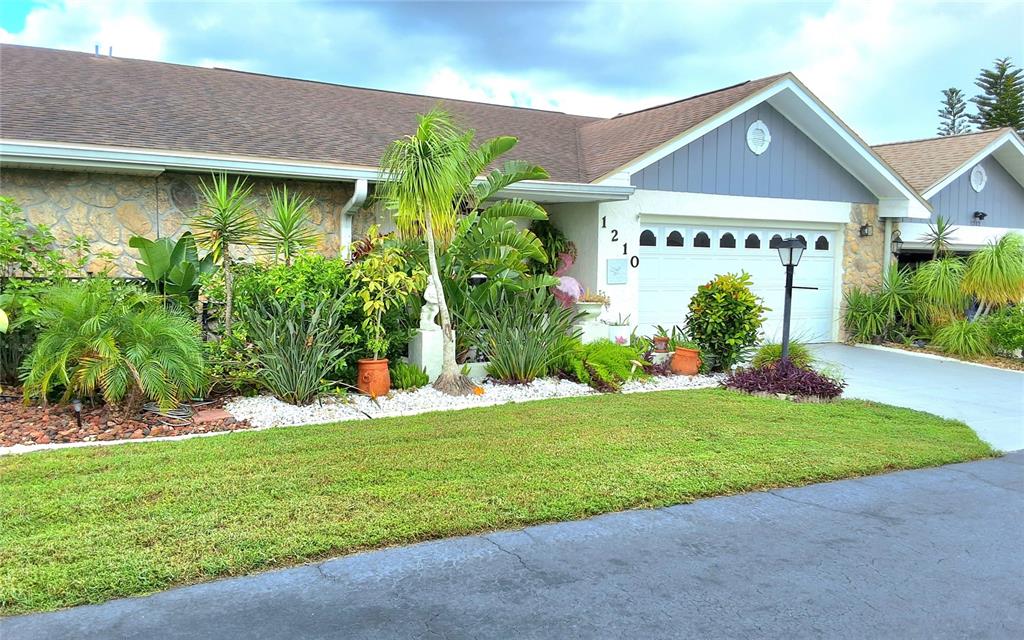 a front view of a house with garden