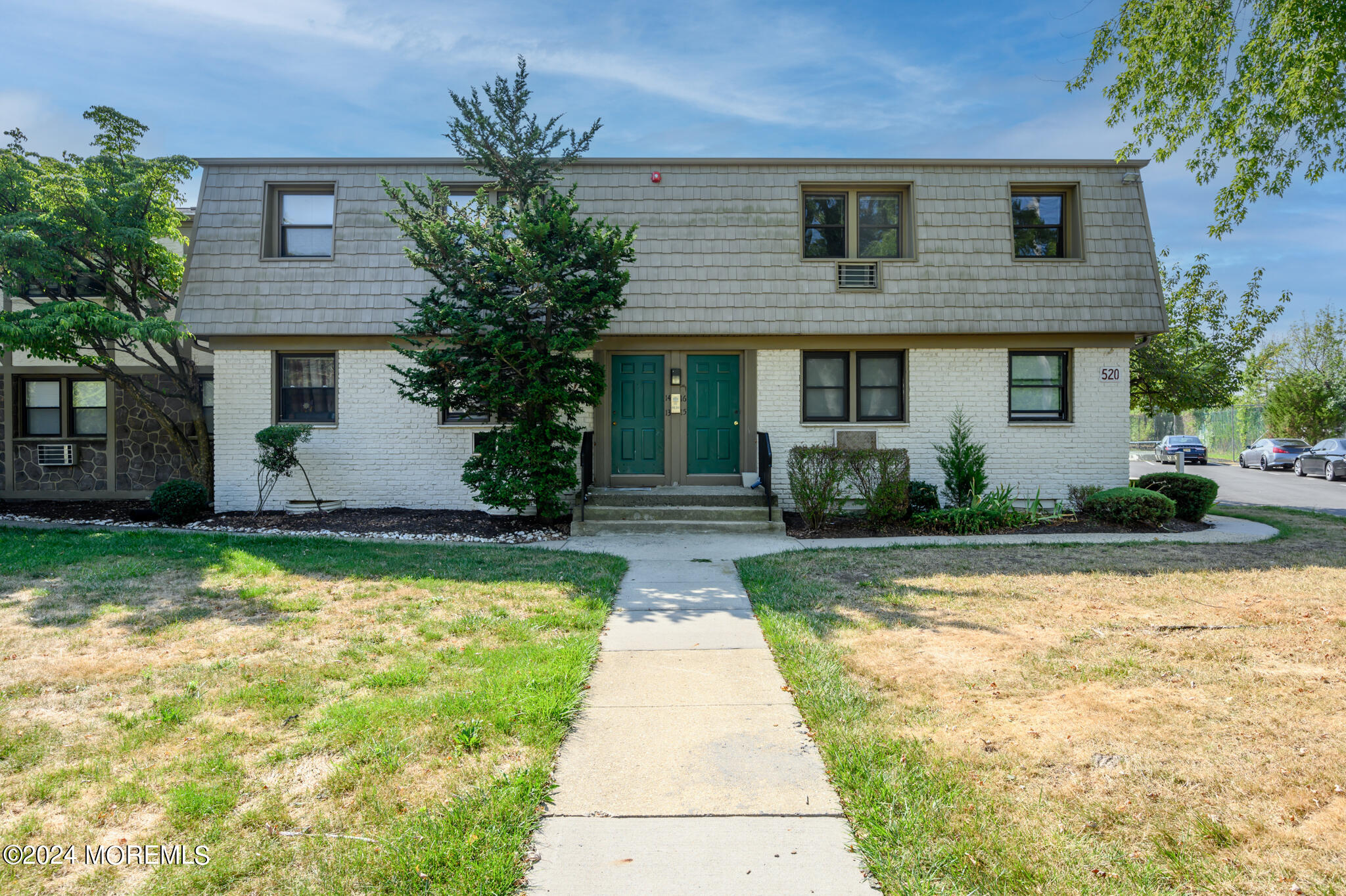 a front view of house with yard and green space