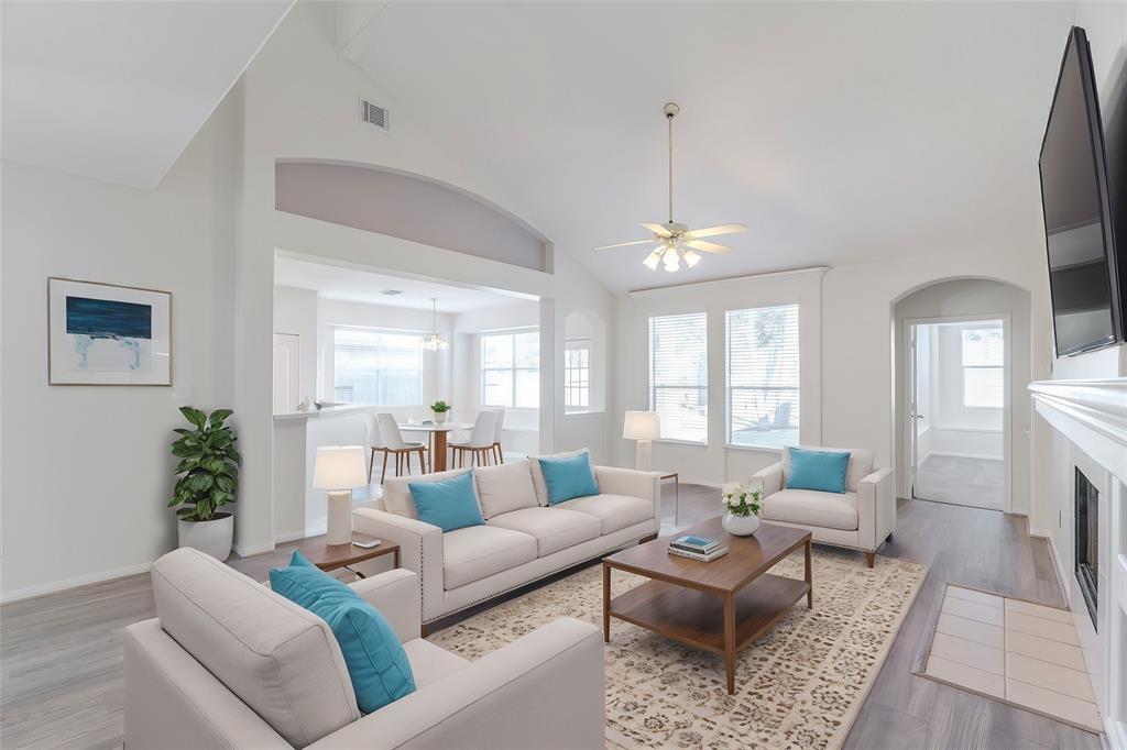 a living room with furniture dining area and a chandelier