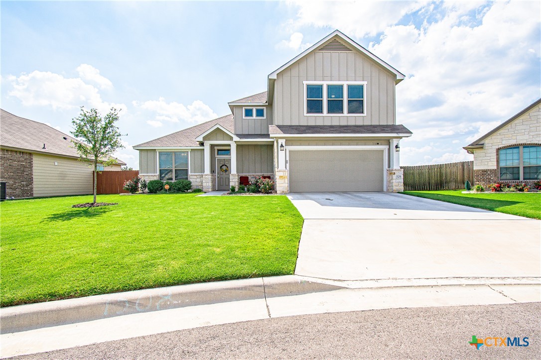 a front view of a house with a garden and yard