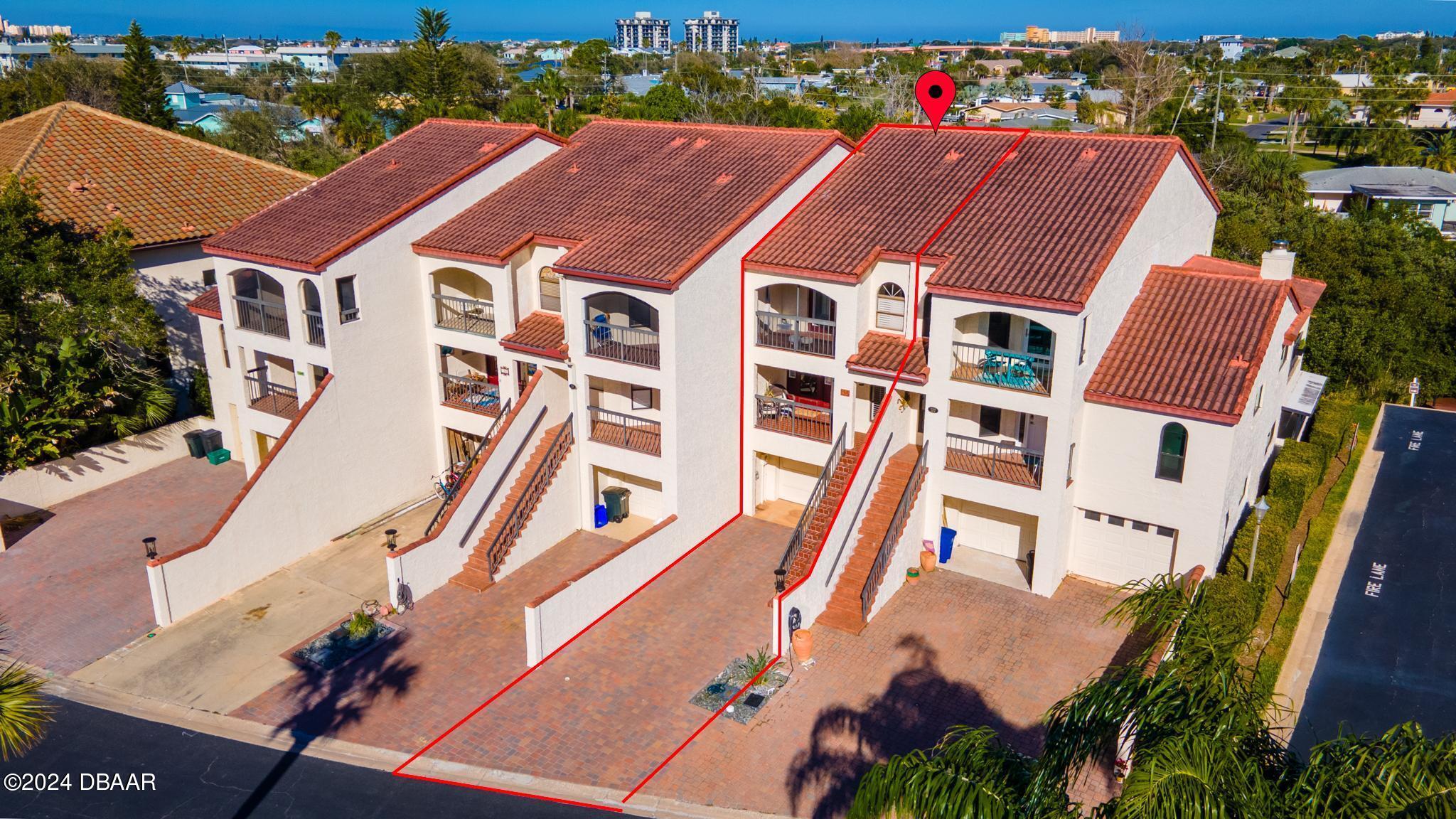 an aerial view of multiple houses with yard