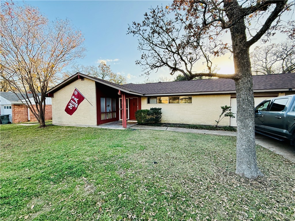 Single story home with a yard