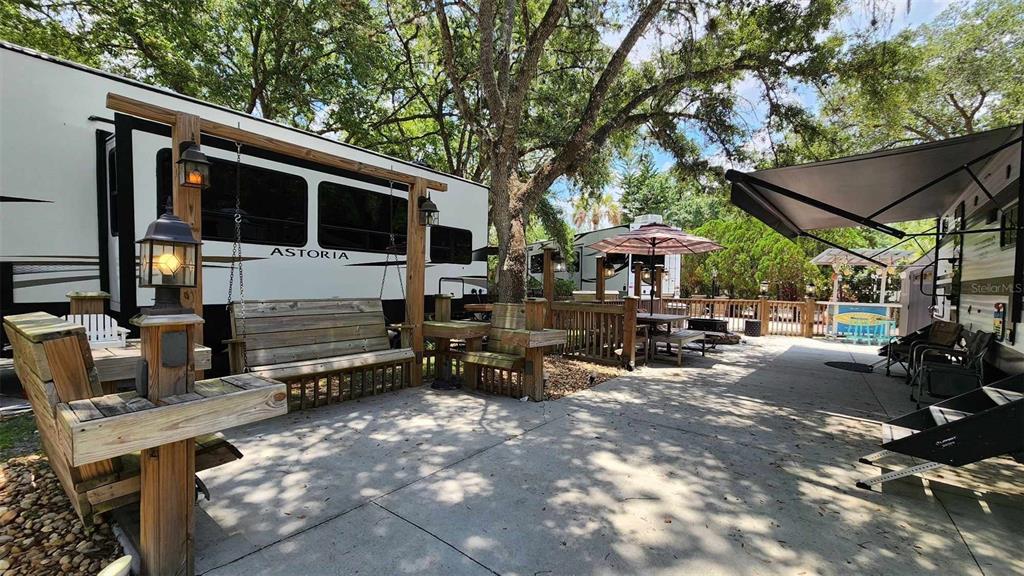 a view of a patio with table and chairs under an umbrella