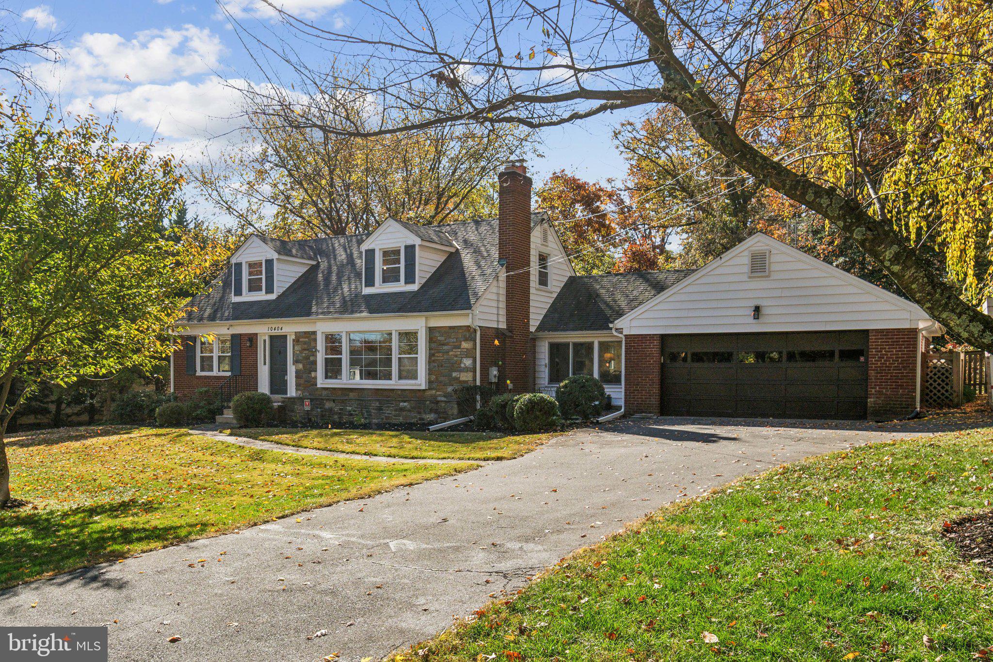 a front view of a house with yard and garage