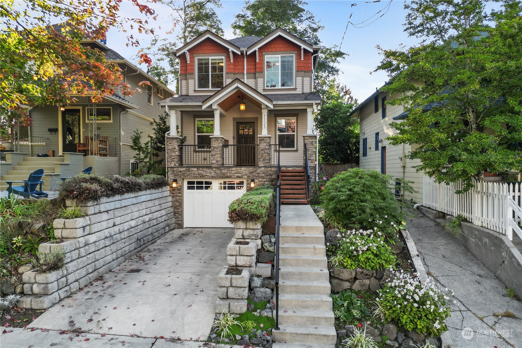 a front view of a house with a yard and potted plants