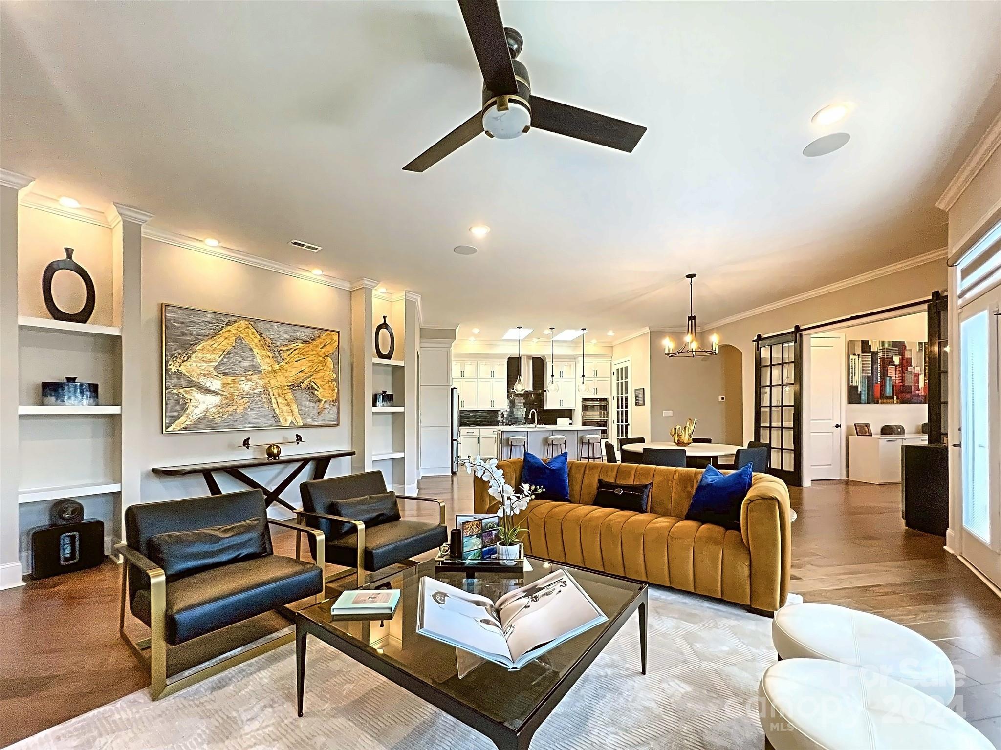 a living room with lots of furniture and a large window