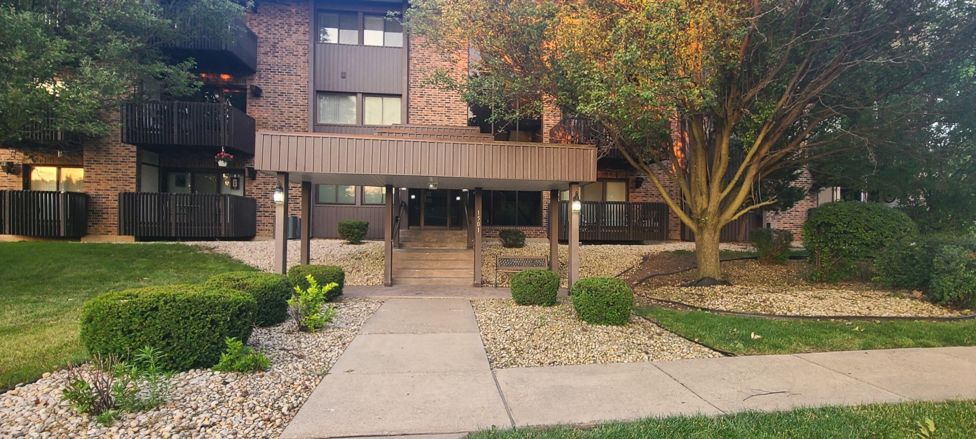 a front view of a house with a garden and plants