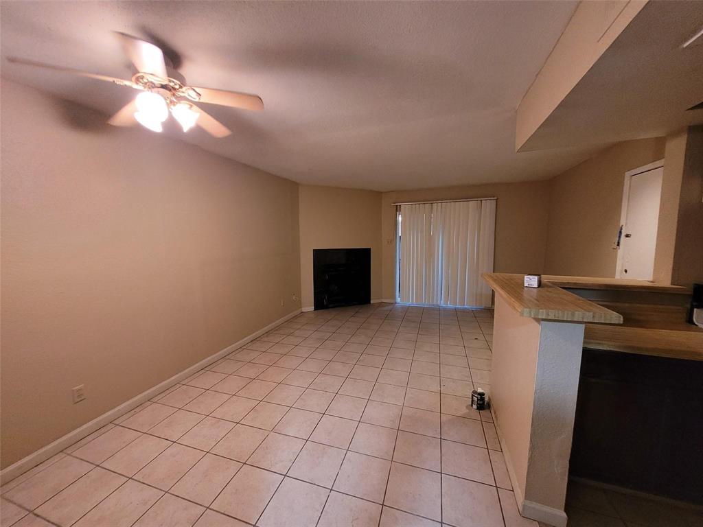 a view of an empty room with a fireplace