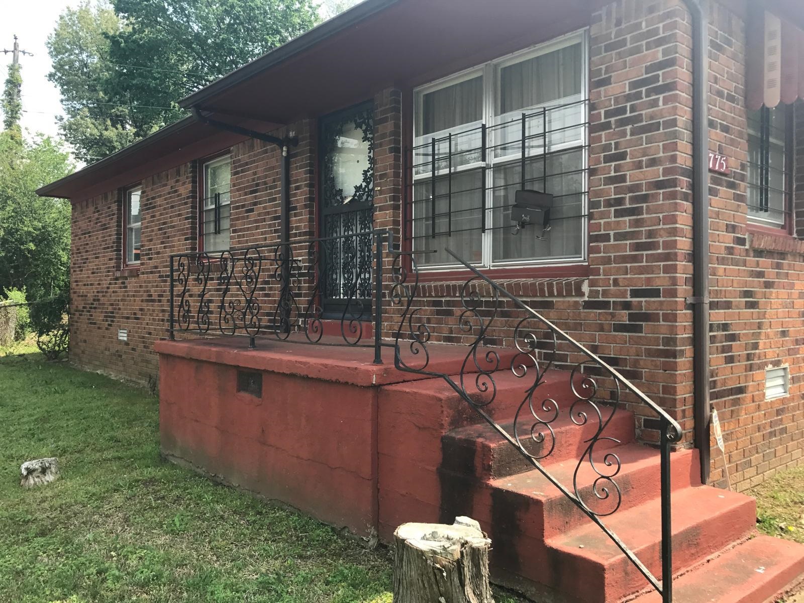 View of side of home featuring a yard