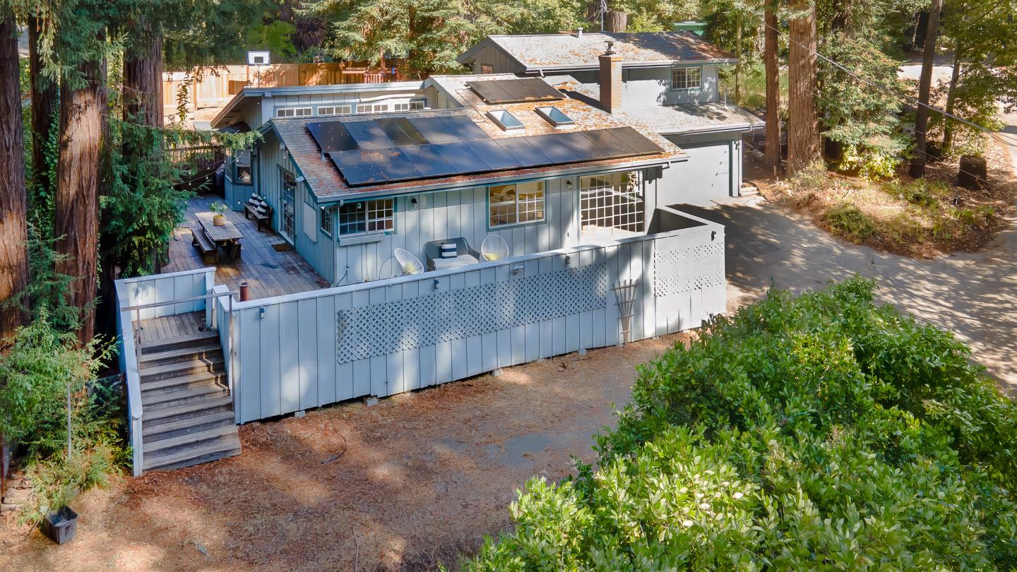 an aerial view of a house with balcony and trees