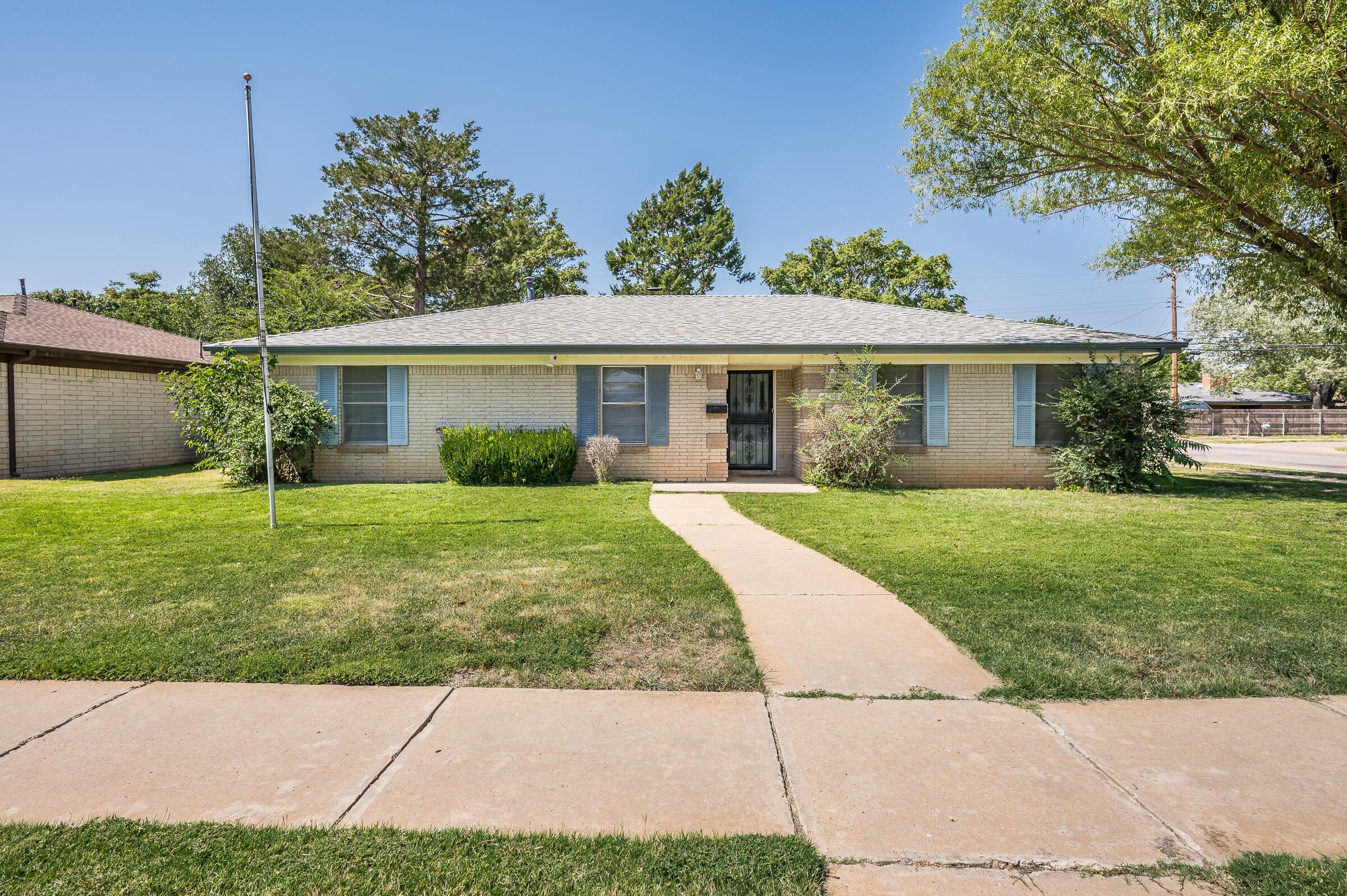 a view of house that has a yard