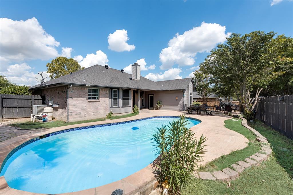 a view of a house with backyard porch and sitting area