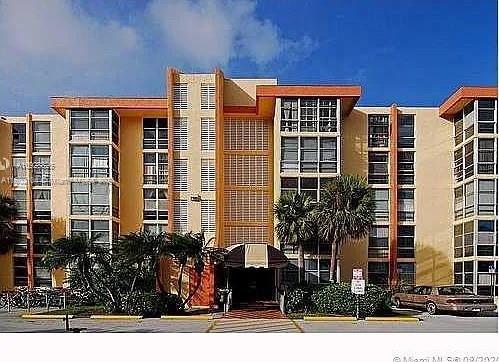 a front view of a residential apartment building with a yard