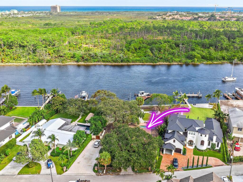 an aerial view of a house with a lake view