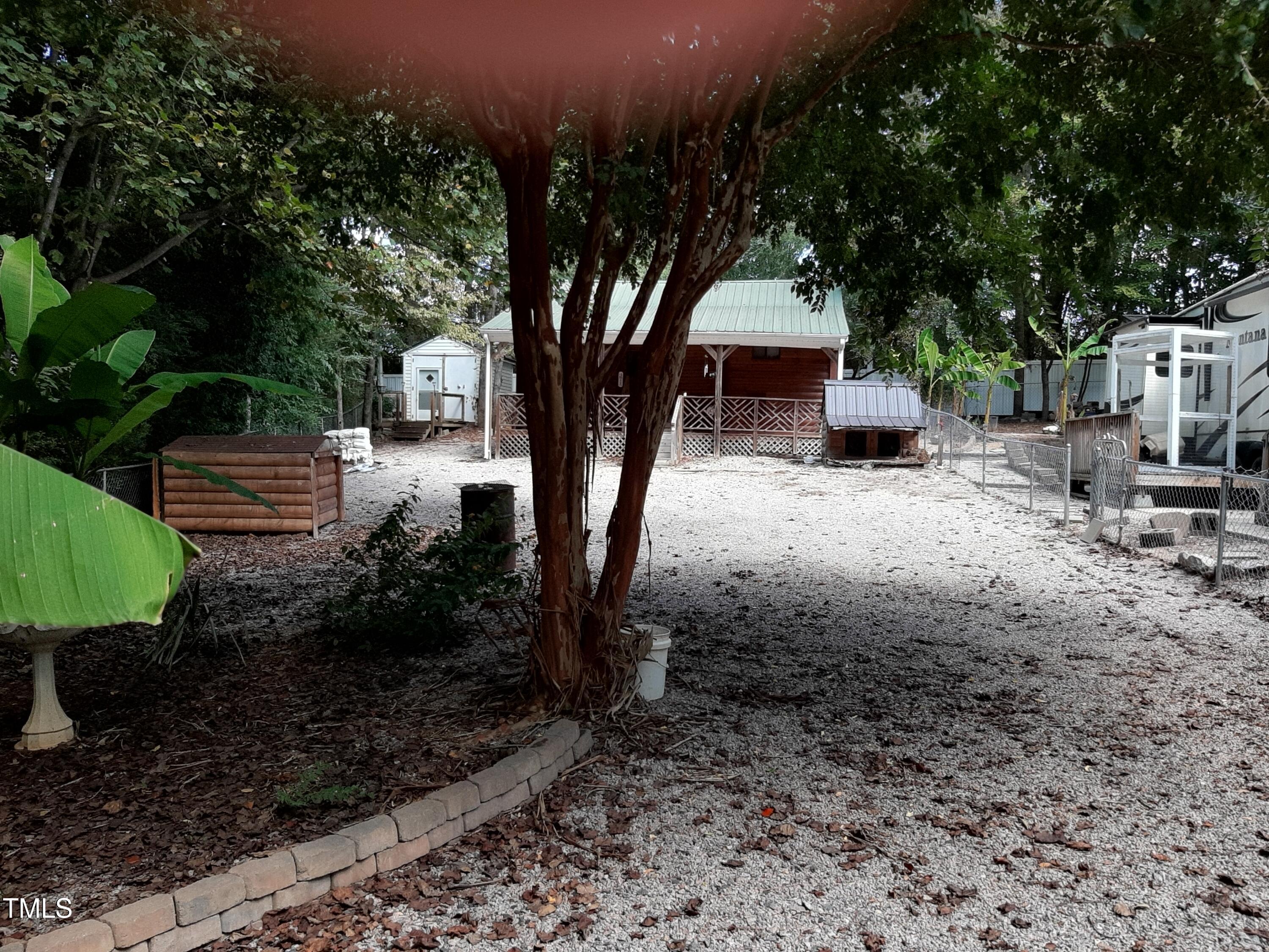 a view of a backyard with sitting area