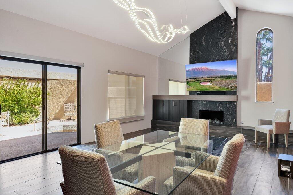 a living room with furniture a fireplace and a floor to ceiling window