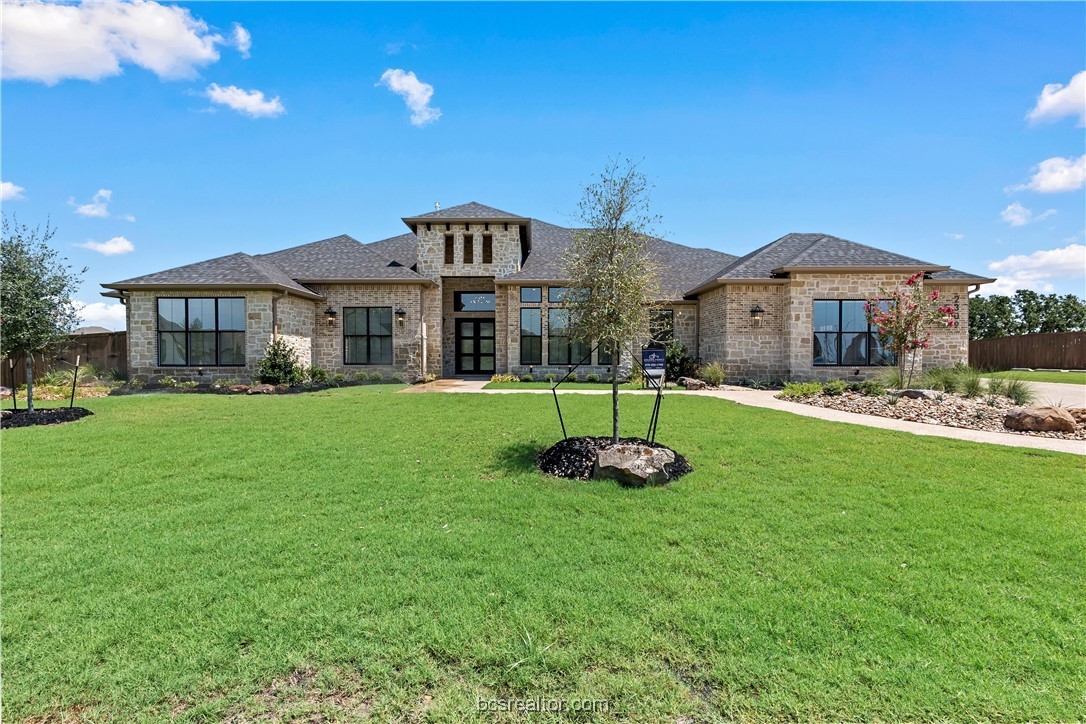 a front view of a house with a yard