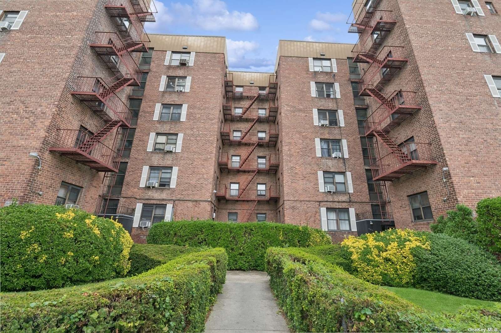 a view of a brick building next to a yard