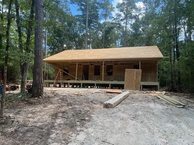 a view of a house with a yard and sitting area