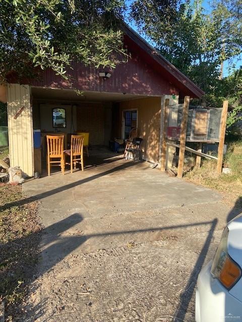 a view of a chairs and table in the patio