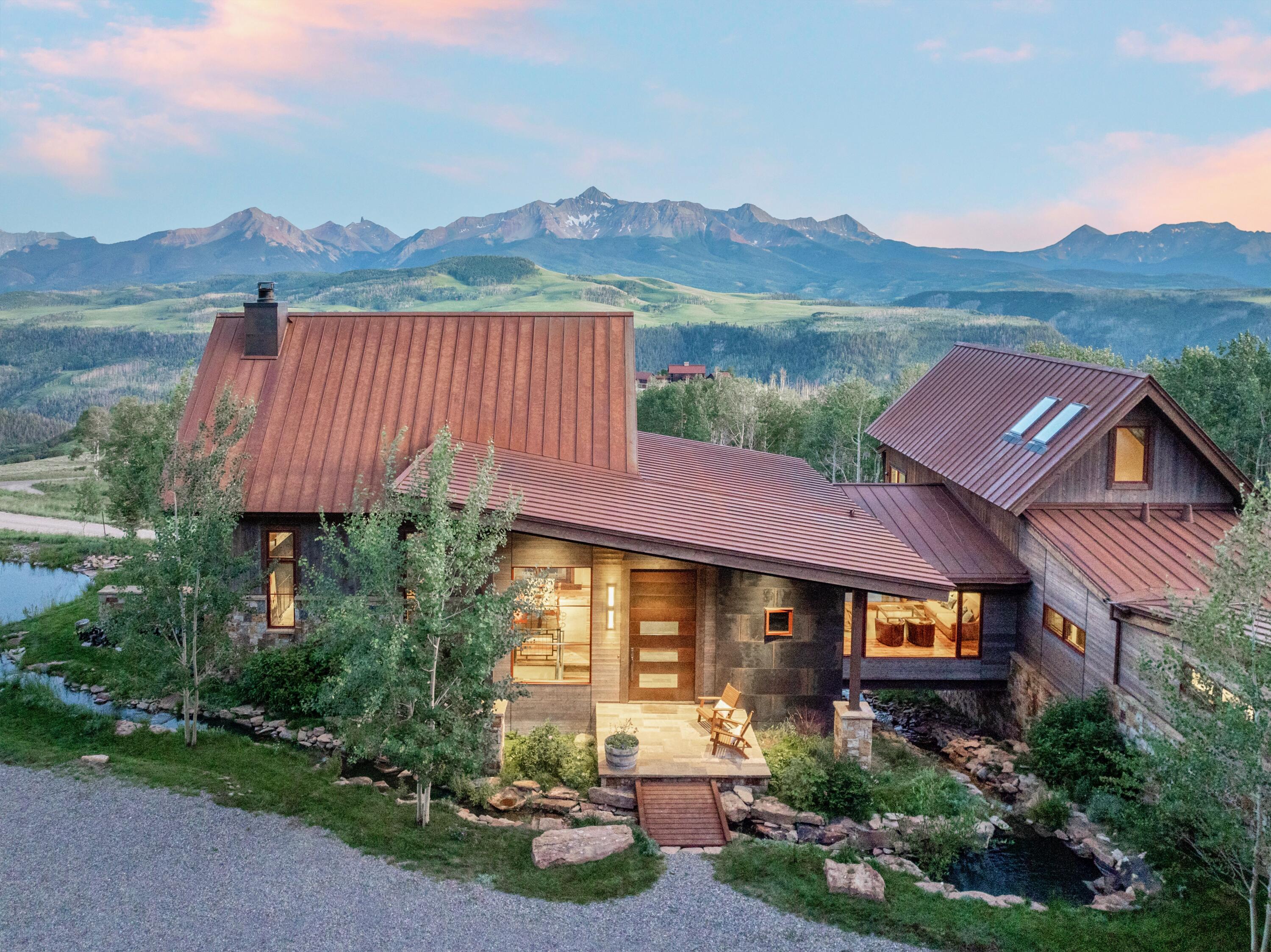 a view of a house with a garden and a mountain